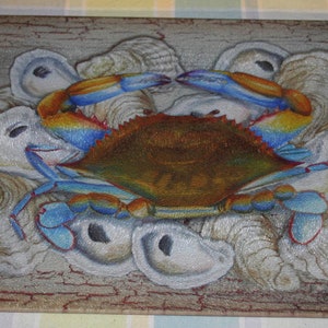 May include: A blue crab with orange claws is surrounded by oyster shells on a wooden cutting board. The cutting board has a distressed, rustic look. The crab is painted in a realistic style, with details like the crab's eyes and legs.