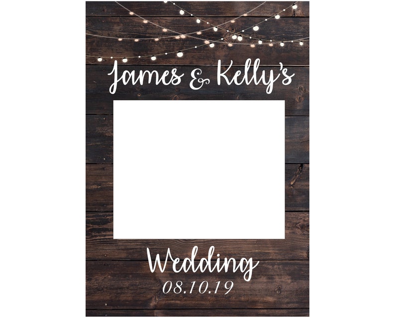 May include: A rustic wooden photo booth backdrop with string lights and the text "James & Kelly's Wedding 08.10.19".
