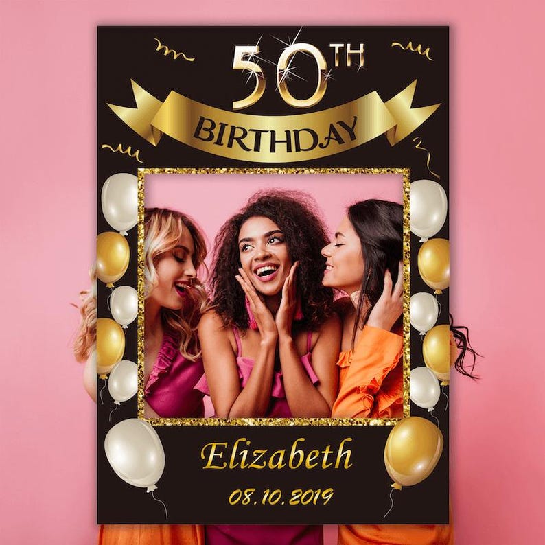 May include: Black and gold photo booth prop with a 50th birthday theme. The prop has a frame with a gold glitter border and gold balloons. The text "50th Birthday" is in gold letters with a gold glitter outline. The text "Elizabeth 08.10.2019" is at the bottom of the frame.
