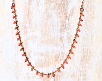 Short thin, delicate necklace decorated with glass beads / handmade