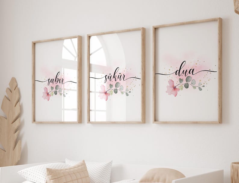 May include: Three framed prints with pink watercolor floral designs and the words "sabur", "shukir", and "dua" in black calligraphy.