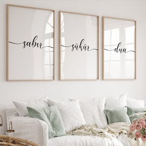 May include: Three framed prints with the words "sabr", "shukr", and "dua" written in black calligraphy on a white background.