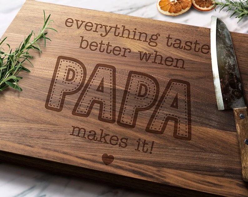 a rectangular cutting board made from wood, engrave the phrase “Everything Tastes Better When Papa Makes It” is the perfect Gift for Papa