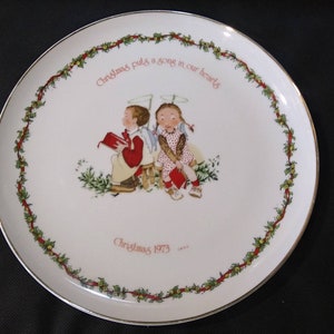 TALERZ HOLLY HOBBIE Boże Narodzenie 1973 „Boże Narodzenie wlewa piosenkę do naszych serc” Talerz kolekcjonerski Worldwide, Inc. 10 3/8&quot;