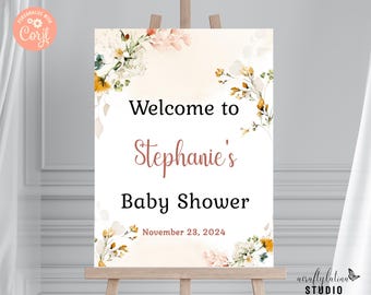 Op de afbeelding: Welkom op Stephanie's Baby Shower bord met een aquarel bloemenontwerp in tinten geel, oranje en wit. Het bord staat op een houten ezel en de datum is 23 november 2024.