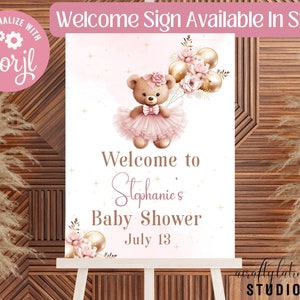 Peut inclure: Un panneau de bienvenue rectangulaire pour une f&ecirc;te pr&eacute;natale repr&eacute;sentant un ours en peluche marron portant un tutu et un n&oelig;ud roses, tenant des ballons dor&eacute;s et roses. Le texte indique Welcome to Stephanie's Baby Shower July 13, avec des &eacute;toiles dor&eacute;es.