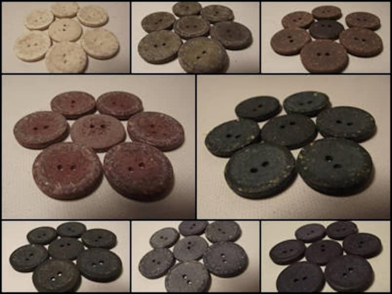 May include: A collection of round buttons in a variety of colours. The buttons are made from a textured material and have two holes for sewing. Colours include cream, grey, brown, and dark blue.