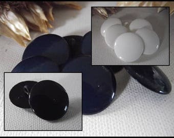 May include: Assortment of round buttons in black, white, and dark blue colors. The buttons are smooth and have a glossy finish.