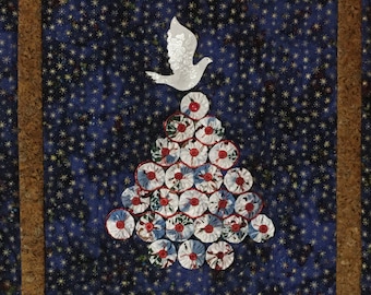 May include: A blue and gold framed wall hanging with a white dove flying above a Christmas tree made of white and red fabric circles on a blue background with white stars.