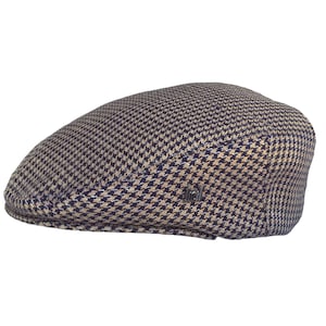 May include: A brown and blue patterned flat cap with a small black label that says "Stetson" on the side.