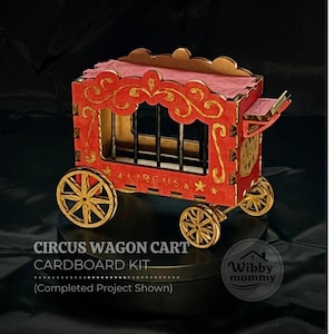 May include: A red and gold cardboard circus wagon cart kit featuring a cage-like structure with vertical bars, four spoked wheels, and decorative scrollwork. The text CIRCUS WAGON CART CARDBOARD KIT (Completed Project Shown) is visible on the image.