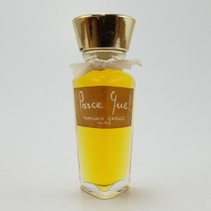 May include: A vintage glass bottle of perfume with a gold cap and a brown label that reads "Parce Que!" PARFUMS CAPUCCI PARIS. The bottle is filled with a yellow liquid.