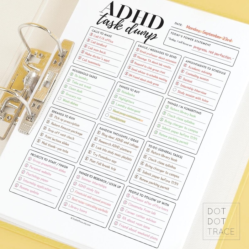 May include: A white paper with a printed ADHD task list, held in a gold binder. The task list includes sections for calls, errands, emails, and appointments. The text "ADHD task dump" is at the top, with the date "Monday, September 23rd."