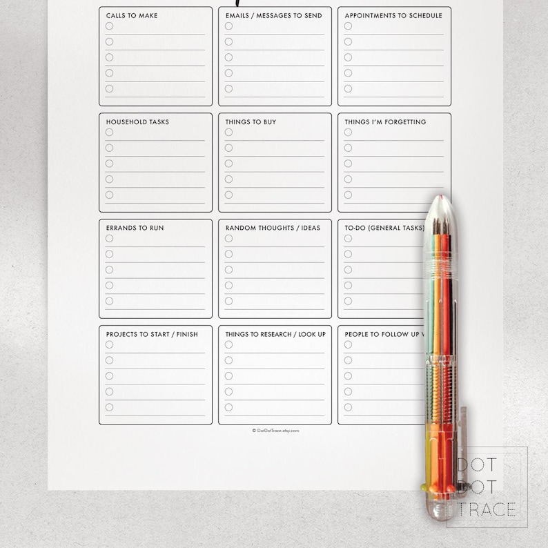 May include: A white to-do list notepad with sections for calls, emails, appointments, household tasks, and more. A multi-colored pen rests on the right side of the notepad. The notepad has the text "DOT DOT TRACE" at the bottom.
