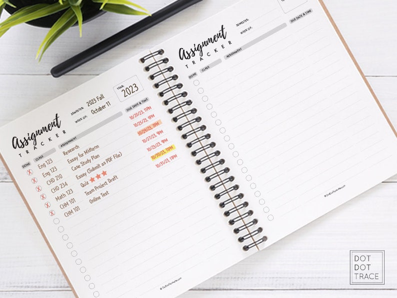 May include: A close-up of a spiral bound planner with a brown cover. The planner is open to a page with a list of assignments and due dates. The page is titled "Assignment Tracker" and includes a section for class, assignment, due date and time. The planner is on a white surface.