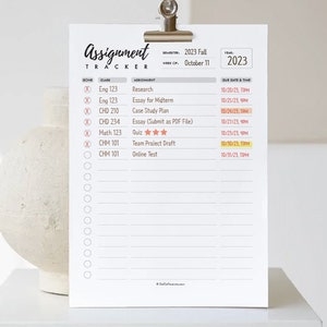 May include: A white printable assignment tracker with a clip at the top. The tracker is labelled "Assignment Tracker" and has a section for class, assignment, due date and time. The tracker is for the Fall 2023 semester and the week of 11th October.