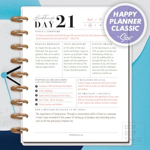 May include: A pink and purple Happy Planner Classic daily planner with a quote about God's love and a daily schedule for prayer, gratitude, and praise. The planner includes a section for individuals or situations calling for intercession, a section for fasting, and a section for God's message revealed to the user.