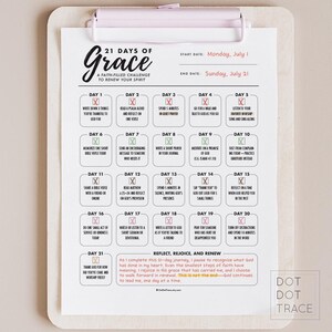 May include: A clipboard with a printed 21 Days of Grace faith-filled challenge. The schedule includes daily prompts for reflection and renewal, with the start date of Monday, July 1, and the end date of Sunday, July 21.