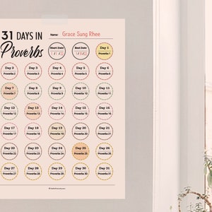 May include: A printable 31-day devotional calendar featuring the book of Proverbs. The calendar is designed with a pink and peach color scheme and features a circle for each day with the day number and the corresponding proverb.