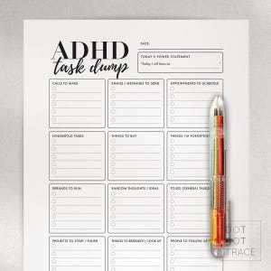 May include: A white ADHD task dump planner with sections for calls, emails, appointments, household tasks, things to buy, and more. A multi-colored pen rests on the right side of the planner. The text "ADHD task dump" is at the top.