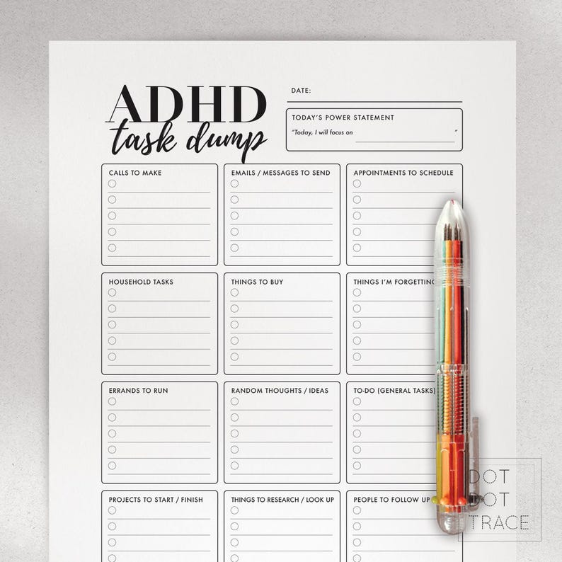 May include: A white ADHD task dump planner with sections for calls, emails, appointments, household tasks, things to buy, and more. A multi-colored pen rests on the right side of the planner. The text "ADHD task dump" is at the top.