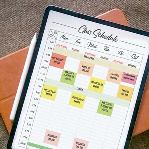 May include: A digital tablet displaying a weekly class schedule with a white stylus pen. The schedule is divided into days of the week, with each day having a list of classes and their corresponding times. The classes include Art History, Political Science, Physics Lab, Math 101, English 101, and Business Online.