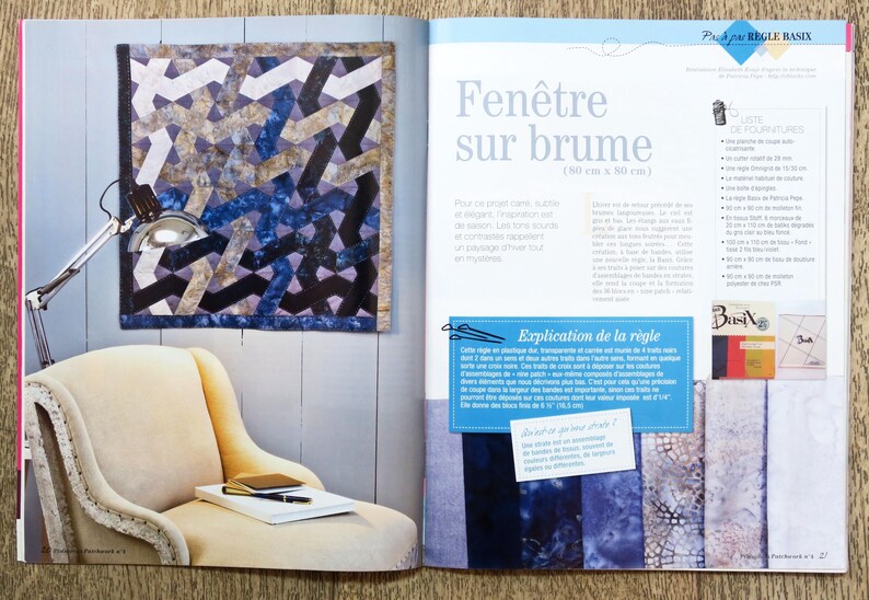 May include: A book page with a blue and gray quilt pattern on the left side of the page. The quilt is 30 inches by 30 inches. The right side of the page has text in French that says "Fen&ecirc;tre sur brume" which translates to "Window on the Fog". The text also says "(30 cm x 30 cm)".