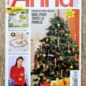 May include: Magazine cover featuring a decorated Christmas tree with ornaments and candles. The magazine title is "Anna" with text in French. Other images show embroidery and festive decorations.
