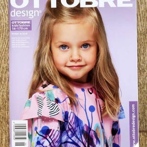 May include: A magazine cover with the title "OTTOBRE design" featuring a young girl with blonde hair and blue eyes. The magazine is for kids fashion, with a size range of 56-170 cm. The cover has a pink background and the girl is wearing a pink top with a floral design.
