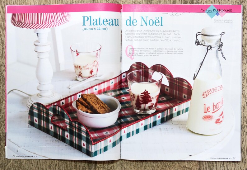 May include: A red and green plaid tray with scalloped edges. The tray is filled with cookies, a glass of milk, and a bottle of milk. The tray is labeled "Plateau de Noel (33 cm x 22 cm)".