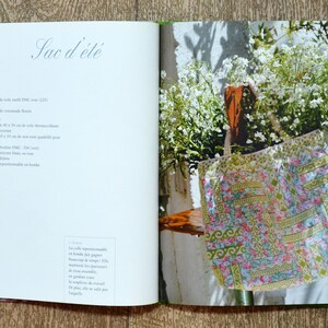 May include: A book page with the title "Sac d'&eacute;t&eacute;" and a list of materials needed to make a summer bag. The page also includes a photo of a colourful patchwork bag.