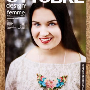 May include: Magazine cover with a woman smiling, wearing a floral necklace. The magazine is titled "OTTOBRE design femme" and includes text about European sizes and the Autumn/Winter 5/2016 issue. The website address is www.ottobredesign.com.