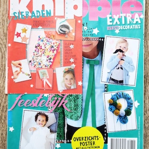 May include: A magazine cover with the title "Knippie" and the subtitle "Extra Kerstdecoraties." The cover features images of children, crafts, and festive decorations. The magazine is in Dutch.