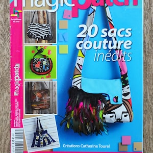 May include: A magazine cover featuring the title "magicpatch" in pink and white letters. The cover features a blue and white bag with colorful feathers and the text "20 sacs couture inédits".