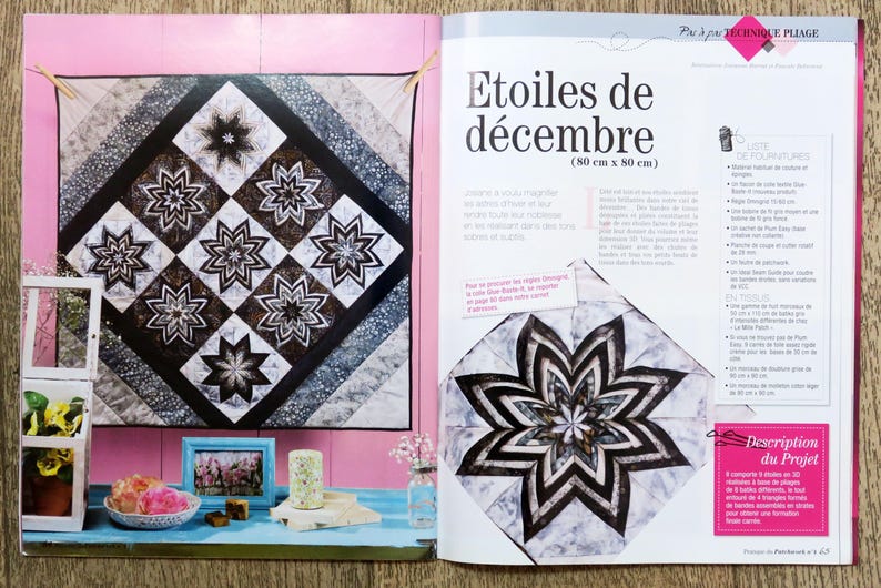 May include: A magazine page featuring a quilt pattern with black and white stars. The quilt is 32 inches by 32 inches. The magazine page also includes a larger star pattern with a white background and black and gray accents. The text on the page reads "Etoiles de d&eacute;cembre (80 cm x 80 cm)" and "Description du Projet".