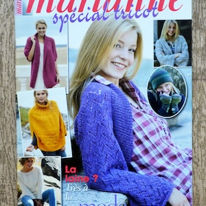 May include: A magazine cover featuring the title "marianne special tricot" with a purple knitted cardigan, a yellow knitted poncho, a pink knitted cardigan, and a white knitted sweater. The magazine cover also features the text "les idées de marianne" and "La laine? Très à la... mode".