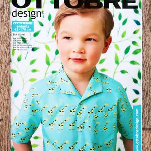 May include: The Ottobre Design magazine cover shows a child in a turquoise shirt with a giraffe pattern. The magazine title is in black, with text indicating the issue is for children, sizes 62-170 cm. The background has a green leaf design.