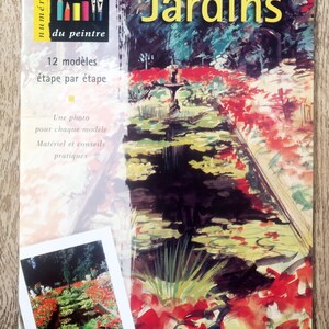 May include: Book cover with the title "Jardins" and a watercolor painting of a garden with a pond and red flowers. The book is part of a series called "Les cahiers du peintre" and features 12 models to paint step-by-step.