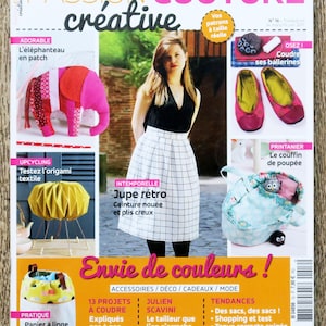 May include: A magazine cover with the title "PASSION COUTURE créative" in pink and black. The cover features a woman in a black top and a white plaid skirt. Various sewing projects are displayed, including an elephant, origami, and a doll's bed.