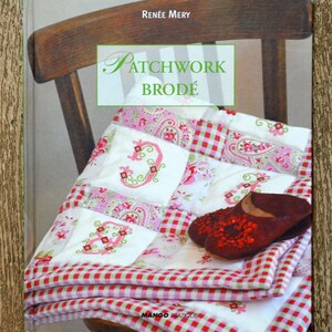 May include: A book titled "Patchwork Brodé" by Renée Mery, featuring a red and white checkered fabric with embroidered letters and a paisley pattern. The book cover shows a quilt with a red and white checkered border.
