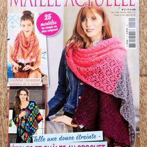 May include: A magazine titled Maille Actuelle featuring crochet patterns. The cover displays three different crochet shawls in pink, gray, burgundy, and multi-colored granny square designs, with text including 25 modèles and Étoiles et châles au crochet.