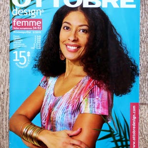 May include: Magazine cover with a woman with dark curly hair and a colourful top. The magazine title "OTTOBRE design femme" is displayed at the top, with the text "Printemps/Été 2/2015" and "15th anniversary" also visible. The website www.ottobredesign.com is shown.