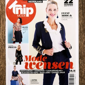 May include: A magazine cover featuring a woman wearing a navy blue blazer with gold trim and a white blouse. The magazine is titled "Thip Mode" and the cover text reads "Feest Mode & Sprankelend Casual". The magazine is a pattern magazine with 22 patterns for sizes 34 to 54.