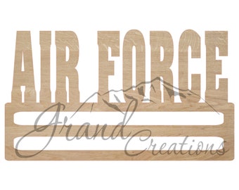 May include: Wooden medal display rack with two shelves and the words "AIR FORCE" cut out in the top. The rack is made of light brown wood.