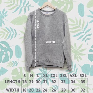 May include: A size chart for a gray sweatshirt with measurements in inches for length and width. The chart shows sizes from small to 5XL.