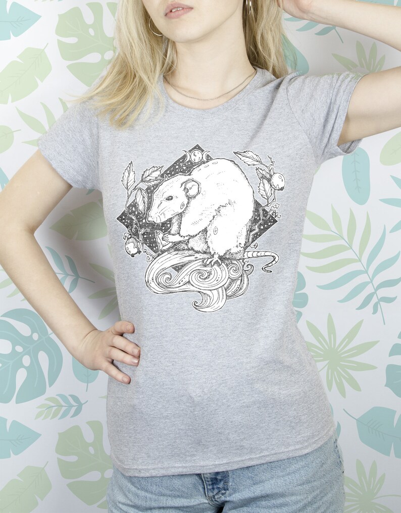 May include: A gray t-shirt with a black and white illustration of a rat in a circle with a crescent moon and stars. The rat is surrounded by leaves and vines.
