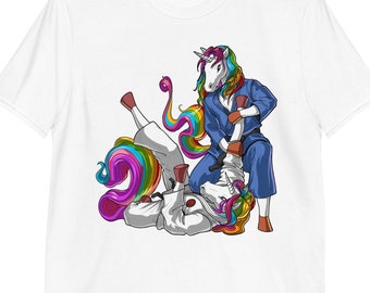 May include: A white t-shirt with a graphic of a rainbow unicorn in a blue gi, performing a jiu-jitsu move on another unicorn in a white gi.