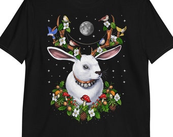 May include: A black t-shirt with a white rabbit wearing antlers with a full moon and birds in the background. The rabbit is surrounded by flowers, mushrooms, and leaves.