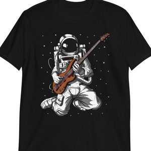 May include: Black t-shirt with a graphic of an astronaut playing an electric guitar in space.
