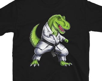 May include: Black t-shirt with a green cartoon dinosaur wearing a white karate uniform and a black belt.